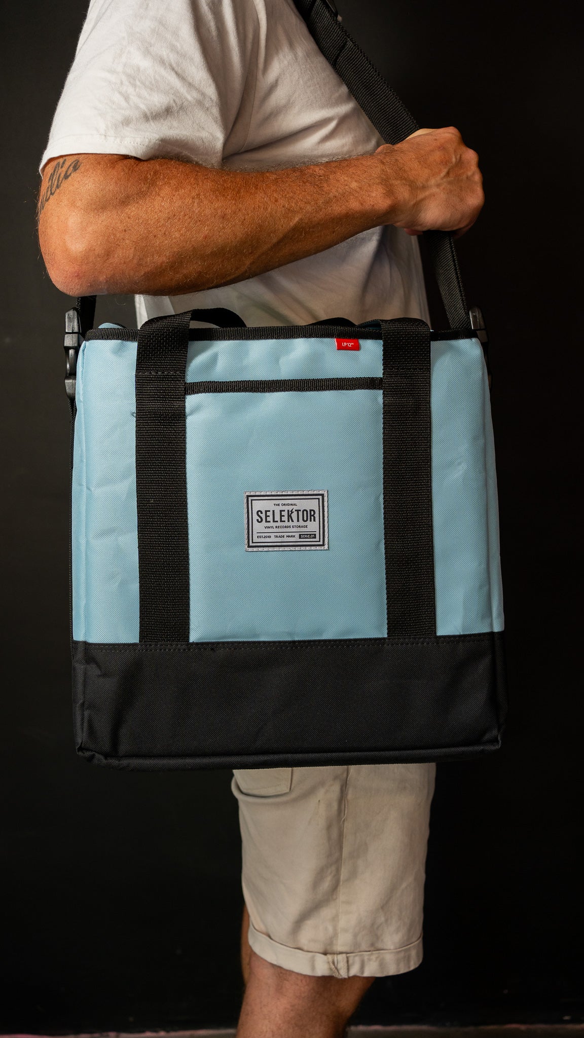 Selektor Messenger Bag, Light Blue and Black, Side View, Held